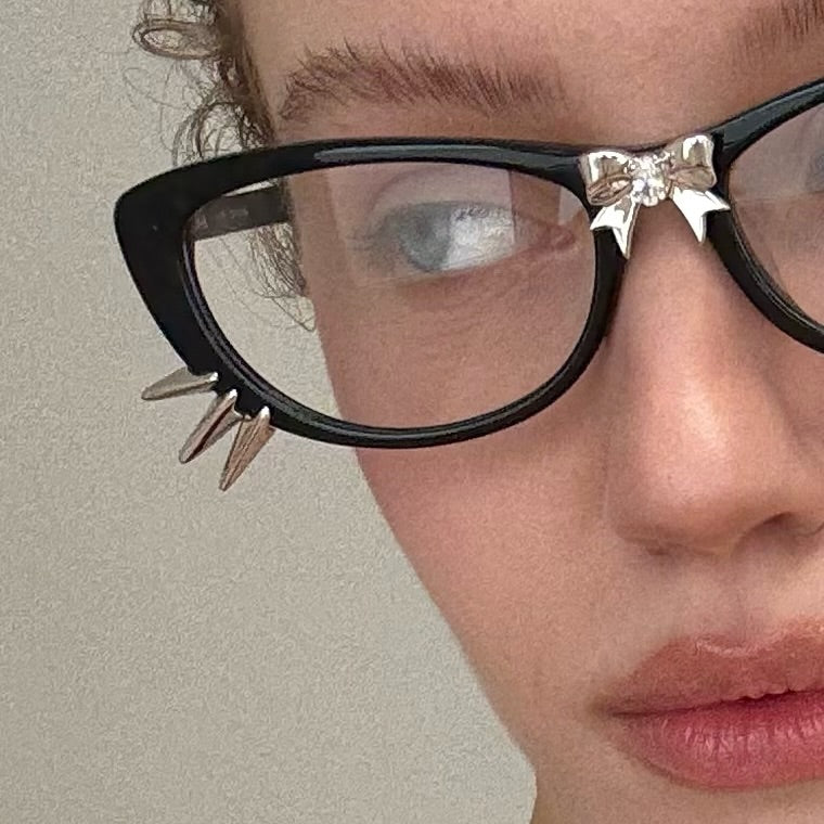 Everyday close-up of bow and cat-whisker glasses