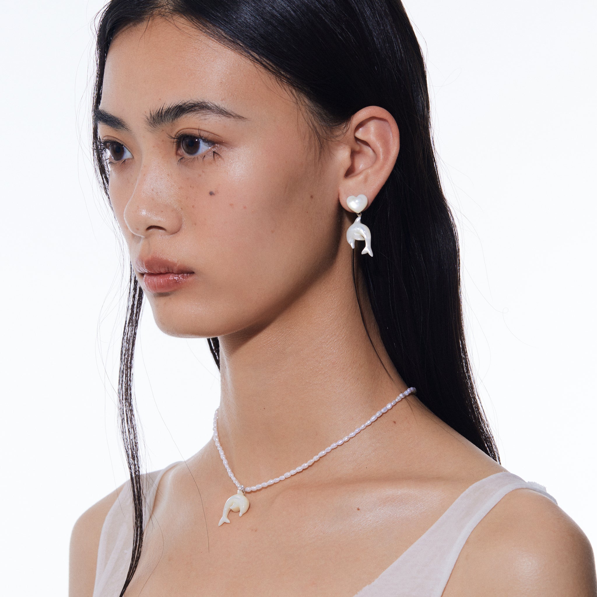 YVMIN carved mother-of-pearl dolphin necklace with natural pearl pendant, featuring intricate dolphin carving on a delicate necklace.