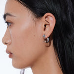 YVMIN interlocking dolphin stud earrings featuring silver-tone dolphins with intricate detailing.