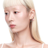 YVMIN X Ashley Williams star-shaped earring featuring a sleek gold finish and modern design, worn on an ear.