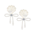 YVMIN carved shell pearl bow stud earrings featuring island-inspired design and delicate craftsmanship.