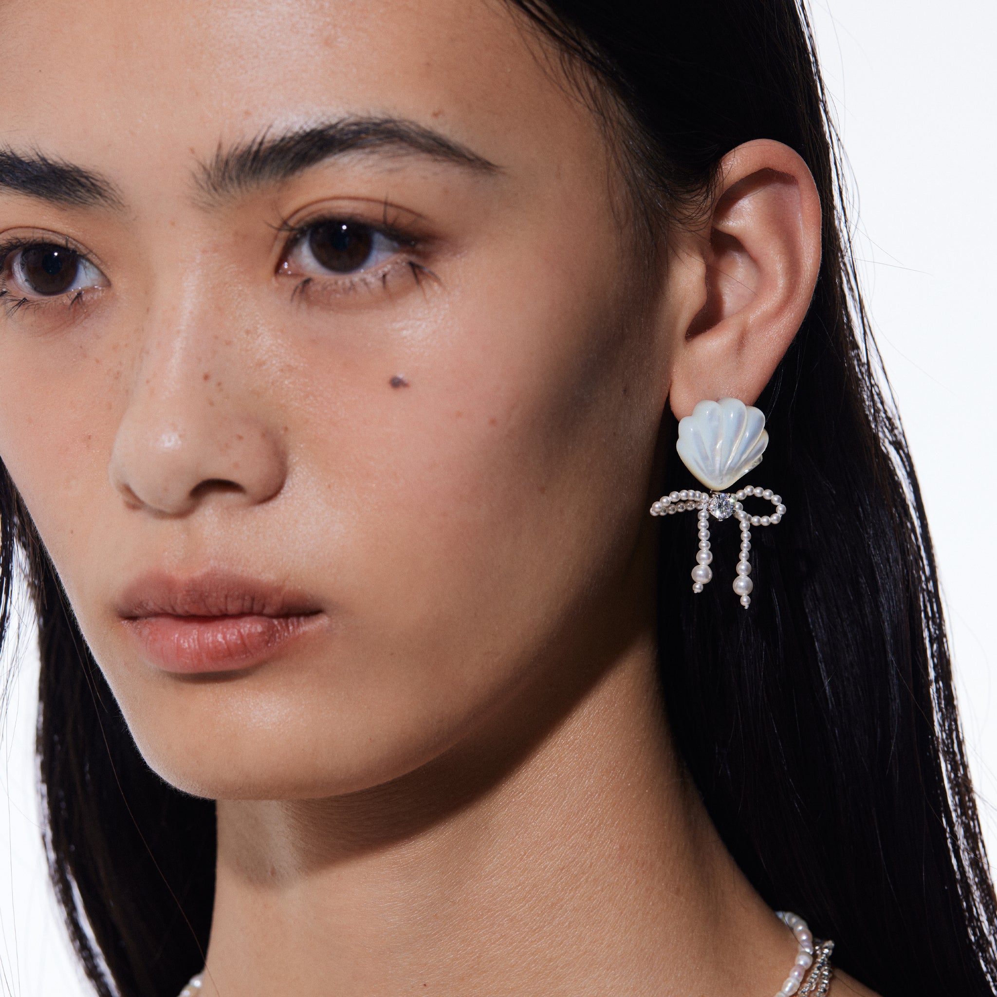 YVMIN carved shell pearl bow stud earrings featuring island-inspired design, perfect for elegant and casual wear
