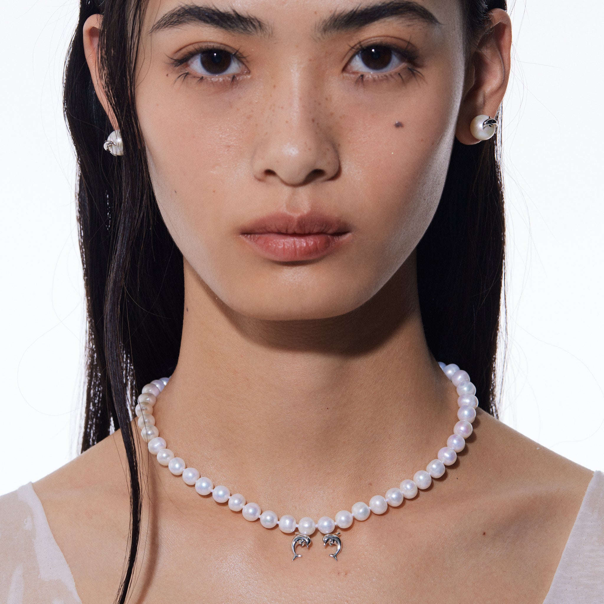 YVMIN double dolphin pearl necklace featuring island-themed design with lustrous pearls and silver dolphin charms.