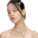 YVMIN Paradise Vines Bowknot Earring featuring delicate vine and bow design in gold-tone metal with floral accents.