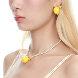 Shop YVMIN  Lemon Necklace. Iconic jewelry worn by aespa members Karina, Winter, Giselle, and Ningning. Elevate your K-pop fashion with this futuristic style.