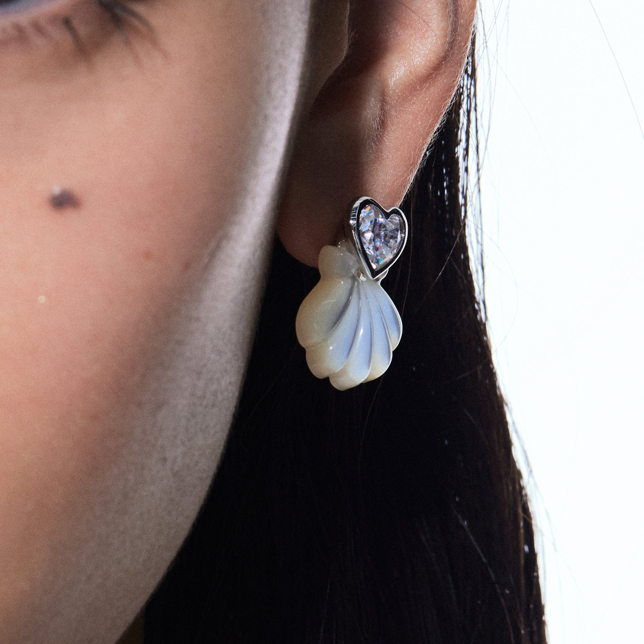 YVMIN carved shell stud earrings featuring island and heart gem designs, showcasing intricate craftsmanship and natural shell patterns.