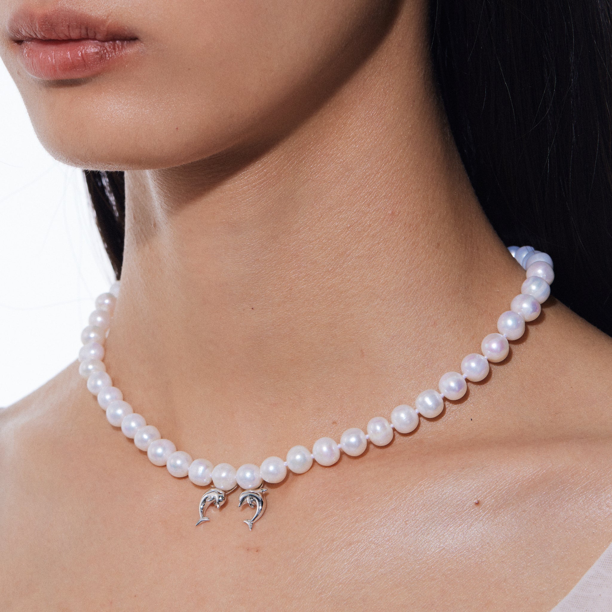 YVMIN Island double dolphin pearl necklace featuring two dolphins and pearl accents on a silver chain.