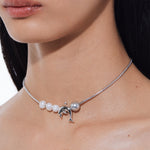 YVMIN Island Dolphin Pearl Snake Bone Necklace featuring a detailed chain and dolphin-shaped pendant on a natural jewelry design.
