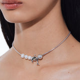YVMIN Island Dolphin Pearl Snake Bone Necklace featuring a detailed chain and dolphin-shaped pendant on a natural jewelry design.