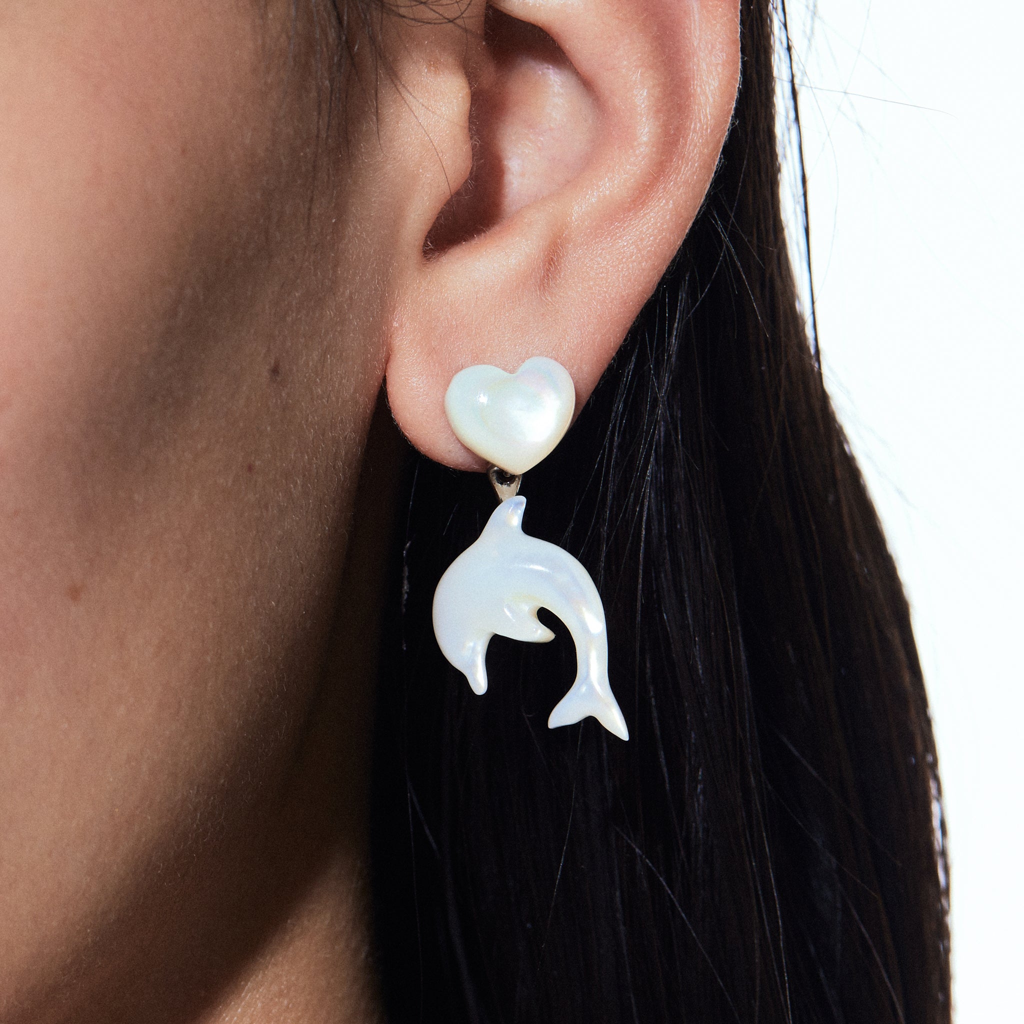 YVMIN dolphin-shaped stud earrings with iridescent mother-of-pearl in island and heart designs, crafted for elegant style.