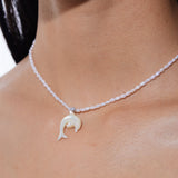 Natural pearl necklace with carved mother-of-pearl dolphin pendant, featuring island-inspired design by YVMIN.