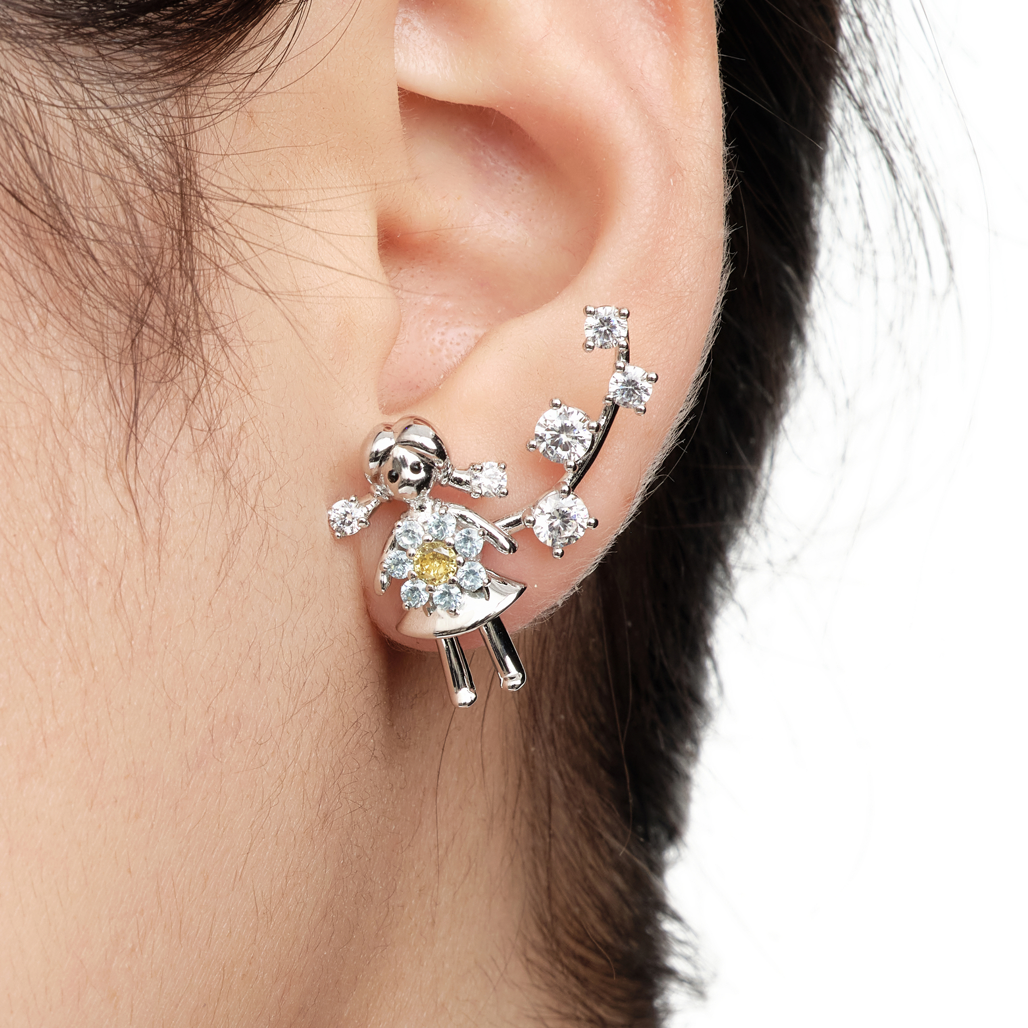 YVMIN Paradise Mini Girl Flower stud earrings featuring small, delicate floral designs on silver posts.