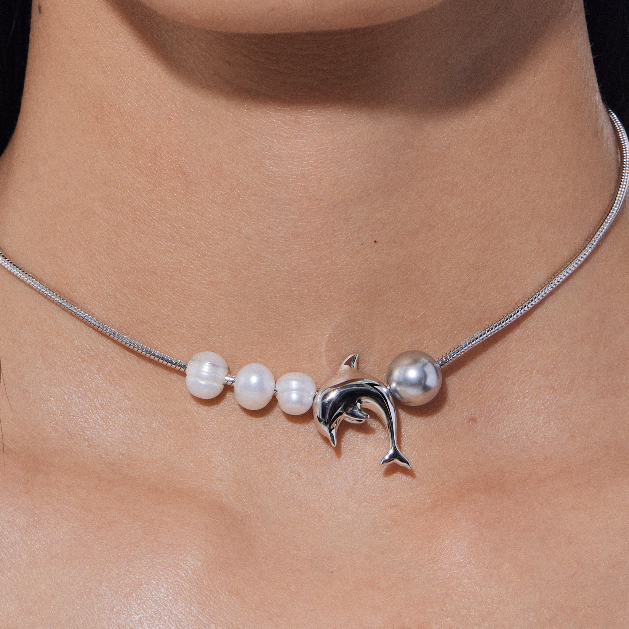 YVMIN Island Dolphin Pearl Snake Bone Necklace featuring a detailed dolphin and pearl pendant on a snake bone chain.