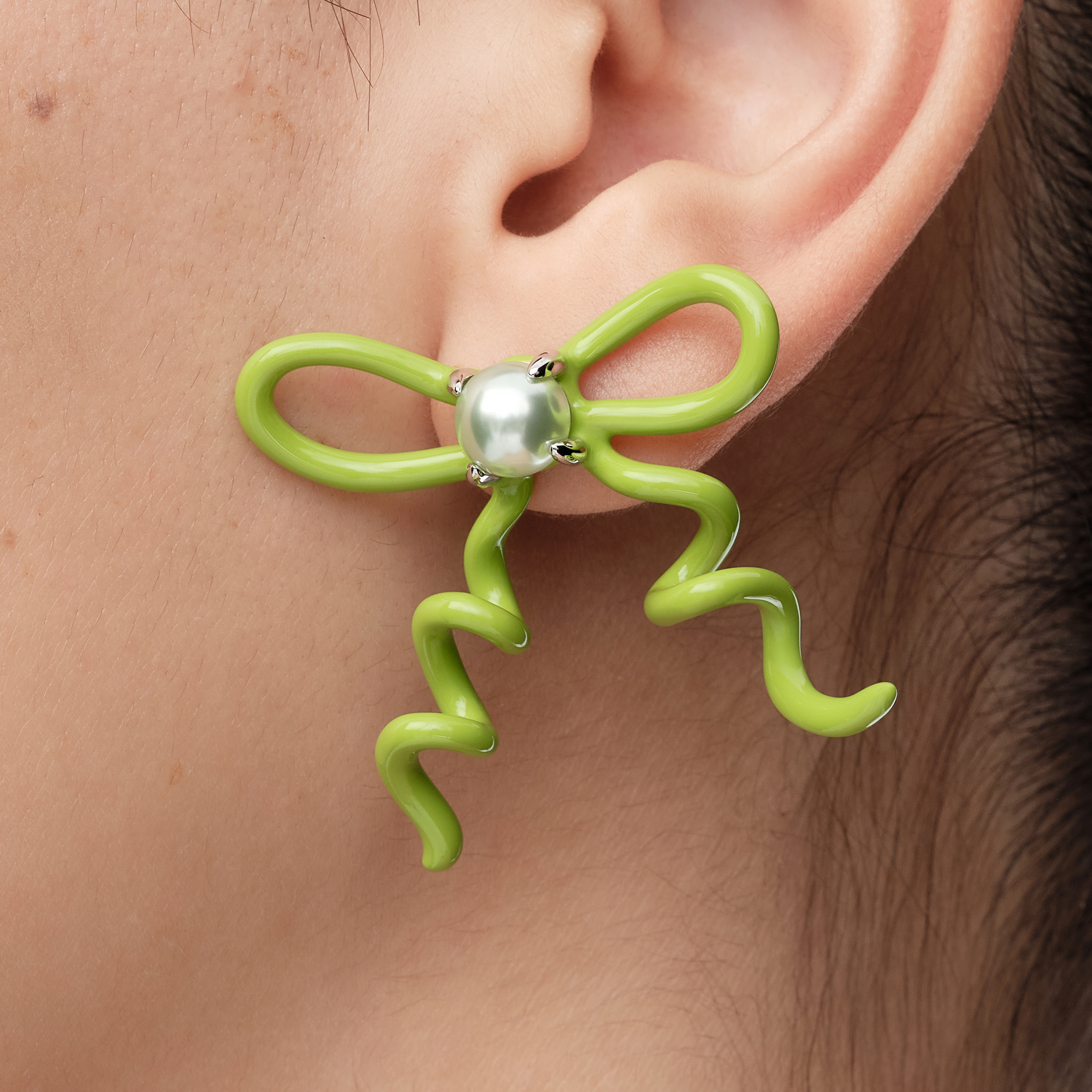 YVMIN Paradise Vines Bowknot Earring featuring a delicate bowknot design with vine details on shiny metal.