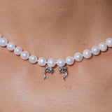 YVMIN Island double dolphin pearl necklace featuring a silver chain with two dolphin charms and a central pearl.