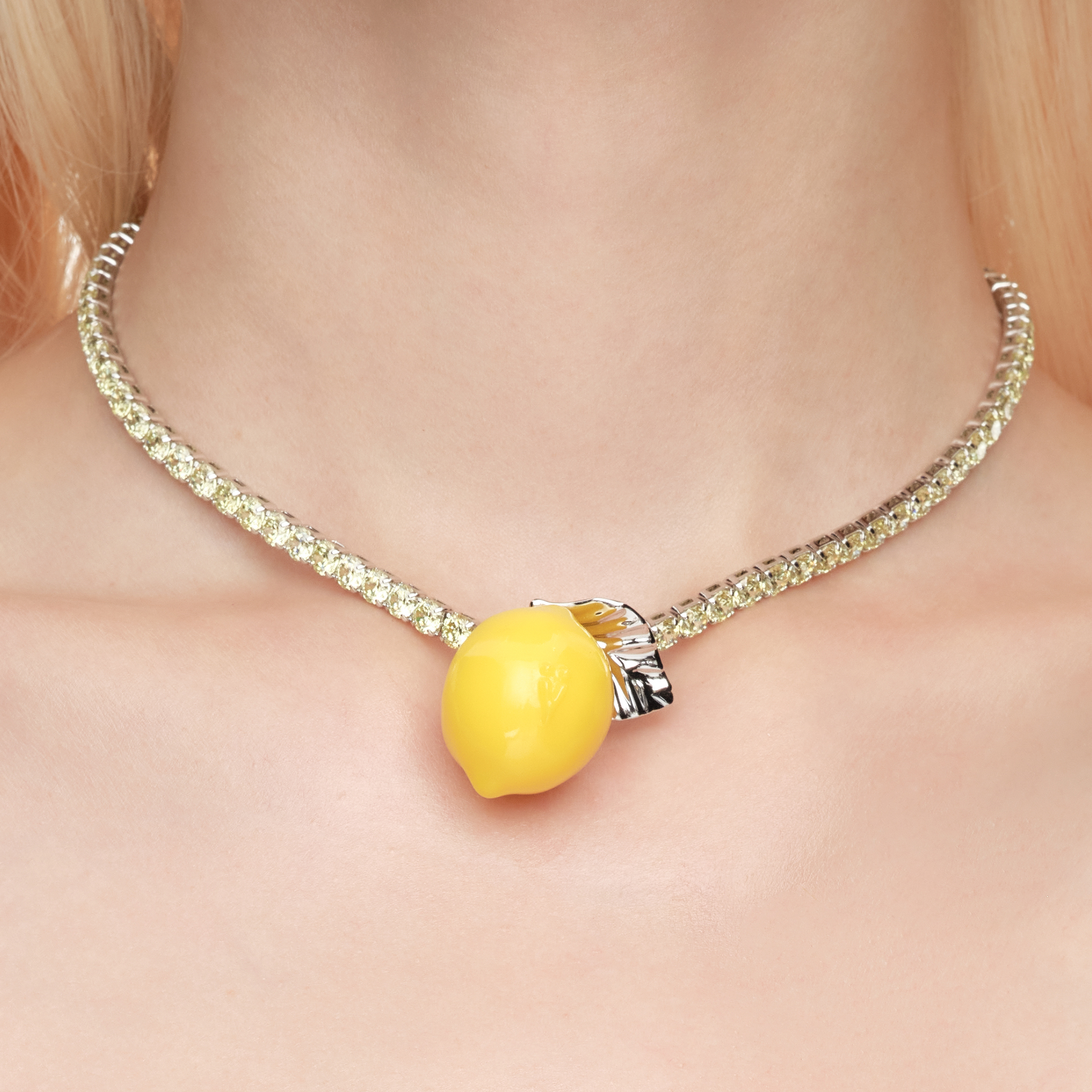 Shop YVMIN  Lemon Necklace. Iconic jewelry worn by aespa members Karina, Winter, Giselle, and Ningning. Elevate your K-pop fashion with this futuristic style.