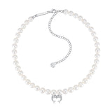 YVMIN Island double dolphin pearl necklace featuring a gold chain and two dolphin charms with pearl accents.