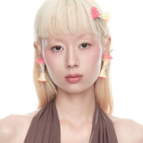YVMIN Paradise Apple Core earring worn on model, gold-tone jewelry with a unique apple core design, stylish and elegant accessory